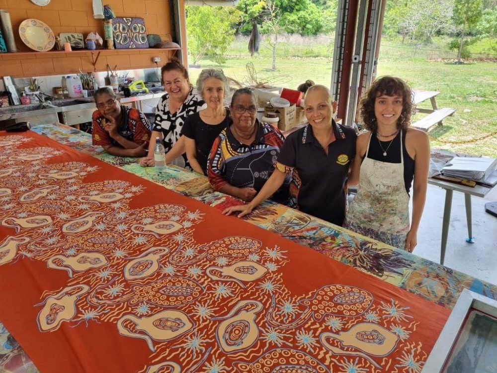 Donna Robinson with artists screen printing in studio at Yarrabah art centre. Photo by Bernie Singleton 2021.